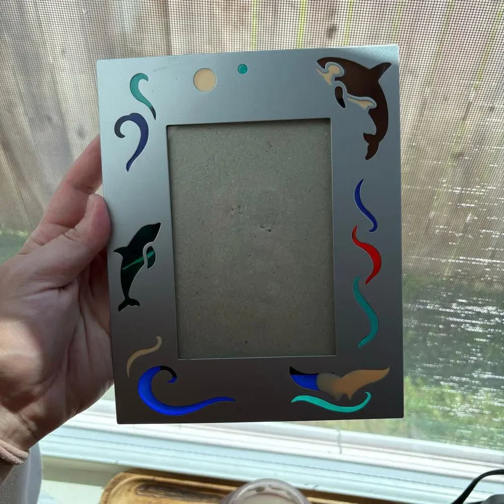 Vintage metal frame with dolphin and orca colorful designs
